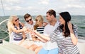 Smiling friends with glasses of champagne on yacht Royalty Free Stock Photo