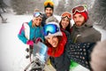 Smiling friends having fun on winter hodays. Snowbarders and ski Royalty Free Stock Photo