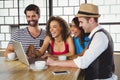 Smiling friends looking at laptop and having coffee Royalty Free Stock Photo