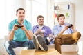 Smiling friends playing video games at home Royalty Free Stock Photo