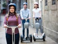 Smiling friends posing on segways in vacation