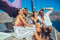 Smiling friends sailing on yacht.