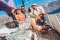 Smiling friends sailing on yacht.