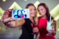 Smiling friends taking selfie in nightclub Royalty Free Stock Photo