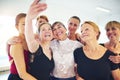 Smiling friends taking selfies together in a dance studio Royalty Free Stock Photo