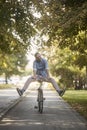 Smiling, funny, ridiculous, young man, 20-29 years old, cycling on road track. legs spread