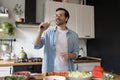 Smiling funny young man wearing glasses singing into whisk Royalty Free Stock Photo