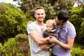 Smiling gay couple with child Royalty Free Stock Photo