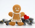 Smiling gingerbread woman, willow twig and red heart Royalty Free Stock Photo