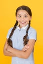 Smiling girl. Adorable schoolgirl yellow background. Little girl. Happy childrens day. Tidy girl nice hairstyle Royalty Free Stock Photo