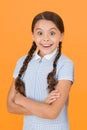 Smiling girl. Adorable schoolgirl yellow background. Little girl. Happy childrens day. Tidy girl nice hairstyle Royalty Free Stock Photo