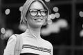 Smiling girl amid glass door black- white photo