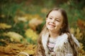 Smiling girl in autumn Leafs. Autumn activities for children. laughing girl. Little child in autumn park