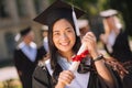 Smiling girl being proud of her masters degree.