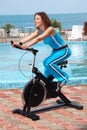 Smiling girl on bicycle training apparatus outdoor Royalty Free Stock Photo