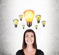 Smiling girl in black and many light bulbs Royalty Free Stock Photo