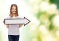 Smiling girl with blank arrow pointing right Royalty Free Stock Photo