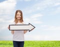 Smiling girl with blank arrow pointing right Royalty Free Stock Photo