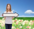 Smiling girl with blank arrow pointing right Royalty Free Stock Photo