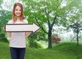 Smiling girl with blank arrow pointing right Royalty Free Stock Photo