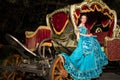 The smiling girl in blue old-fashioned dress sits Royalty Free Stock Photo