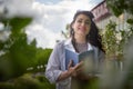 Smiling girl with Book Outdoors. Content woman in blossoming apple. Student, freelancer, coach. The rules of self care Royalty Free Stock Photo