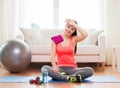 Smiling girl with bottle of water after exercising Royalty Free Stock Photo