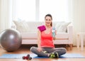 Smiling girl with bottle of water after exercising Royalty Free Stock Photo