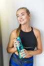 Smiling girl with bottle of water after exercising at home Royalty Free Stock Photo