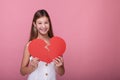 Smiling girl with a broken red paper heart Royalty Free Stock Photo