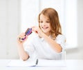 Smiling girl choosing colorful felt-tip pen