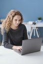 Smiling girl connecting with her laptop