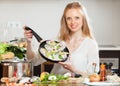 Smiling girl cooking fish with lemon Royalty Free Stock Photo