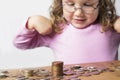 Smiling girl counting money for savings Royalty Free Stock Photo