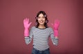 Smiling girl in curlers and rubber gloves for cleaning Royalty Free Stock Photo