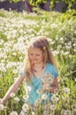 Smiling girl with dandelion flowers