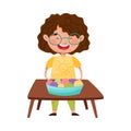 Smiling Girl at Desk Playing with Fluffy Balls Vector Illustration