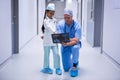 Smiling girl and doctor looking at x-ray in corridor Royalty Free Stock Photo