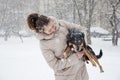 Smiling girl with dog in winter snow Royalty Free Stock Photo