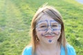 Smiling girl with drawings on face