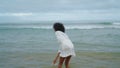 Smiling girl enjoying ocean waves in bikini. Happy woman having fun at sea shore Royalty Free Stock Photo