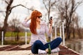 Girl enjoying and relaxing out in nature and taking selfie by th