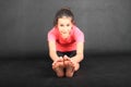 Smiling girl exercising yoga - seated forward fold Royalty Free Stock Photo