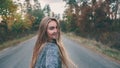 Smiling girl on a forest road. She is looking at the camera. Close-up Royalty Free Stock Photo