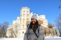 Smiling girl in front of palace Hluboka with terrace