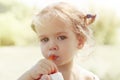 Smiling girl with funny pigtails like Pippi drinks fresh orange juice Royalty Free Stock Photo