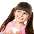 Smiling girl with a glass of milk