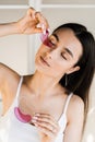 Smiling girl with golden eye patches in bathroom. Cosmetic procedure for smoothing wrinkles, remove swelling or bags Royalty Free Stock Photo