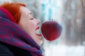 Smiling girl and hanging in air big red apple Royalty Free Stock Photo