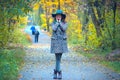 Smiling girl in a hat stands on a trail